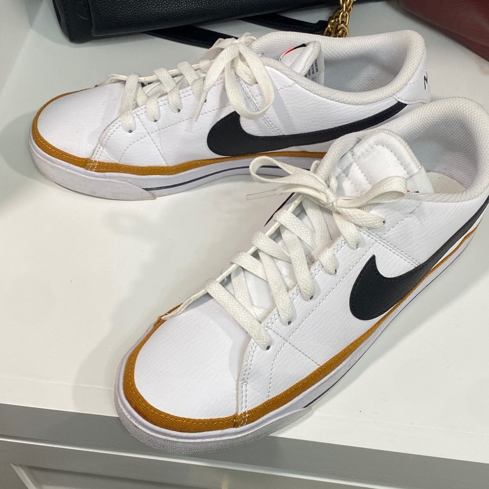 Nike White and Black Sneakers with Gold Accents